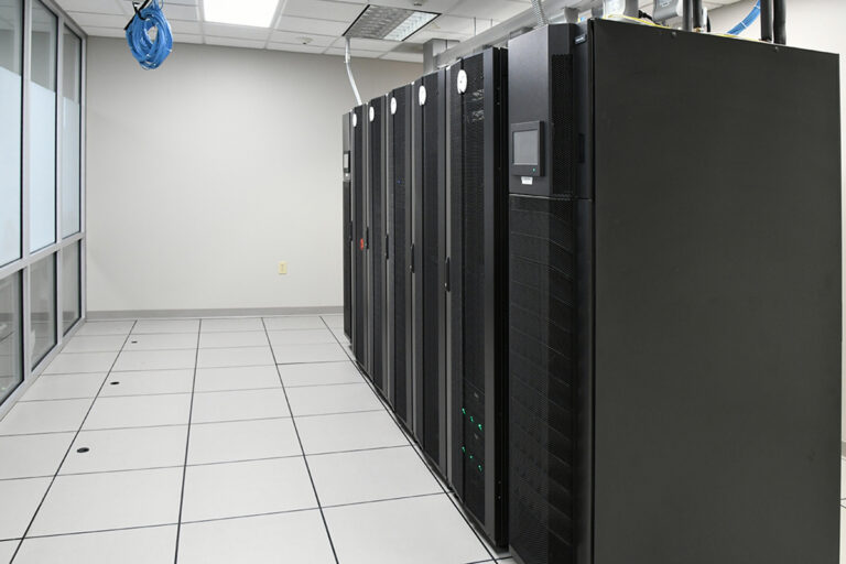 Industrial UPS cabinets line a data center floor, highlighting power backup solutions for critical equipment.